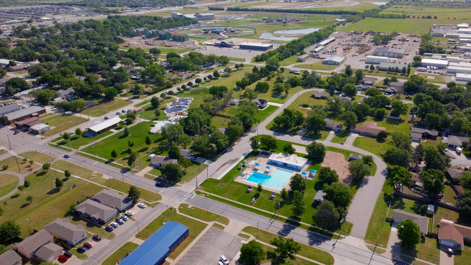 Aerial view of a community pool with slides in a Goddard neighborhood
